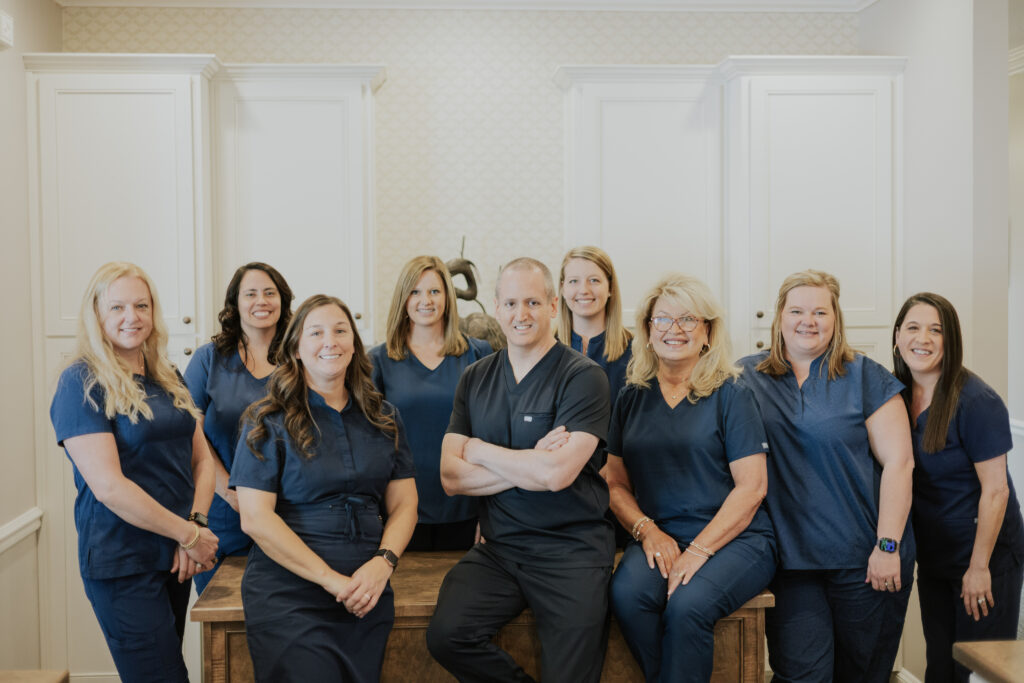 A group photo of dental professionals from Bozeman Dental smiling together.